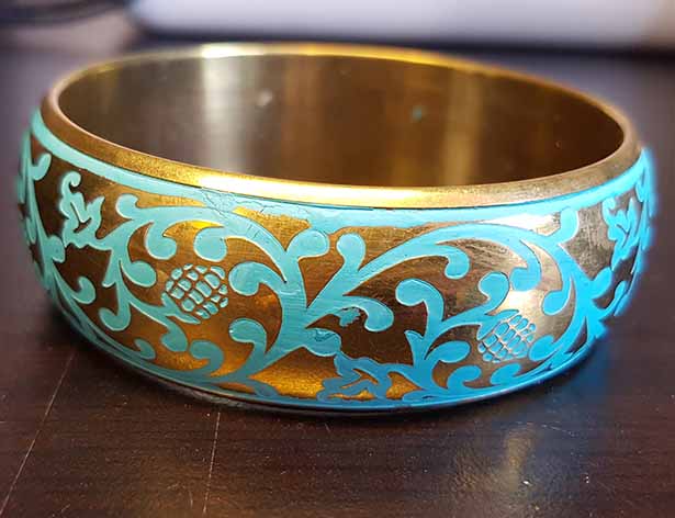 Gold-colored bracelet with turquoise elements