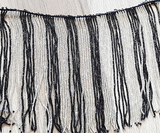Beaded string with black/white strings with many beads

 60cm long, strands 20cm long